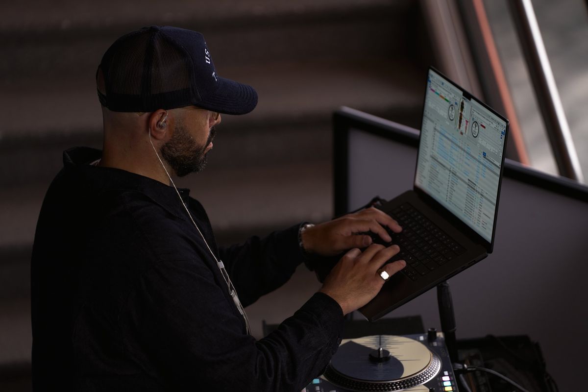 DJ Mode working his laptop beside the turntable