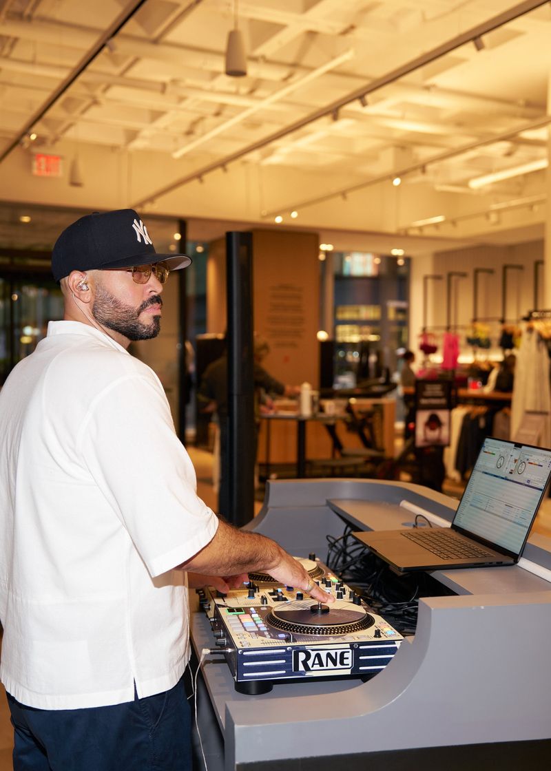 DJ Mode in a Yankees cap at the decks inside a store