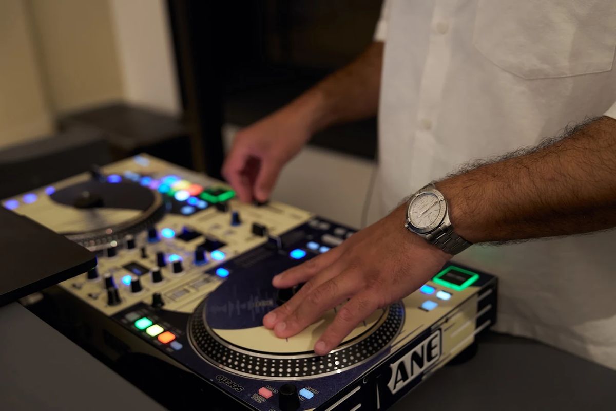 DJ Mode's hands scratching on the Rane turntables