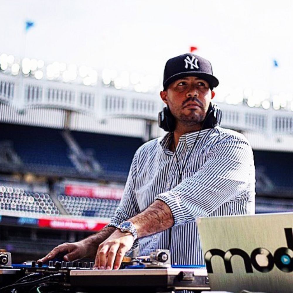 DJ Mode in a Yankees cap at the decks inside Yankee Stadium